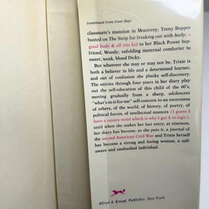 May include: An open book with a yellow spine. The right-hand page features text from a novel, including phrases such as "good body & all rite kid" and "second American Civil War." The publisher's logo and address are visible.