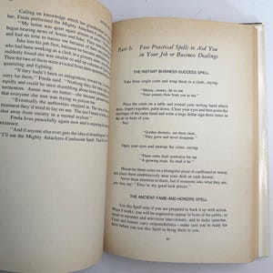 May include: Open book with text on the pages. The text includes the title "Five Practical Spells to Aid You in Your Job or Business Dealings." The text describes spells for business success and fame.