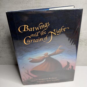 May include: A hardcover book titled "Batwings and the Curtain of Night" with a dark blue cover. The cover features gold lettering and an illustration of a figure with outstretched arms, silhouetted against a night sky with bats and wolves.
