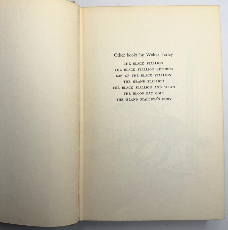 May include: Open book page with a list of titles by Walter Farley. The titles include "The Black Stallion," "The Black Stallion Returns," and "Son of the Black Stallion." The page has a cream-colored background with black text.