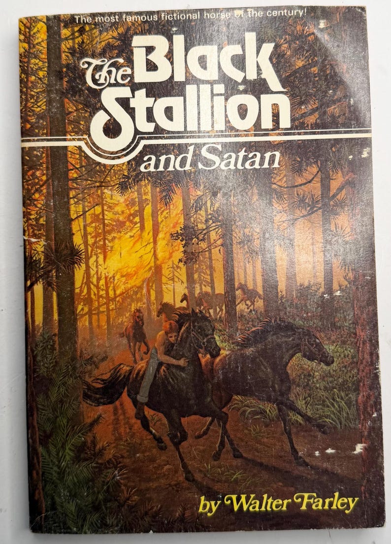 May include: Vintage paperback book cover for "The Black Stallion and Satan" by Walter Farley. The cover features a forest scene with horses and riders, with the title in large white letters. The book is a classic.