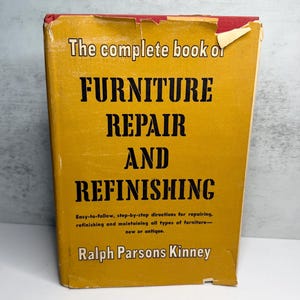 May include: A vintage book titled "The Complete Book of Furniture Repair and Refinishing" with a yellow cover and black text. The book's title is prominently displayed, along with the author's name, Ralph Parsons Kinney. The book provides step-by-step directions for furniture repair.