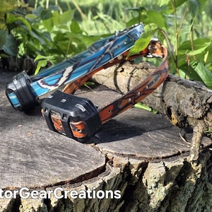 May include: Two electronic tracking collars with black plastic receiver units. One collar features a blue and white camouflage pattern, while the other has an orange and black camouflage pattern. The text RaptorGearCreations is visible.