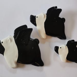 British Saddleback Flying Pigs plaster chalkware wall plaques. Set of 3 x black and white kitsch wall hangers. Hand cast and painted in UK