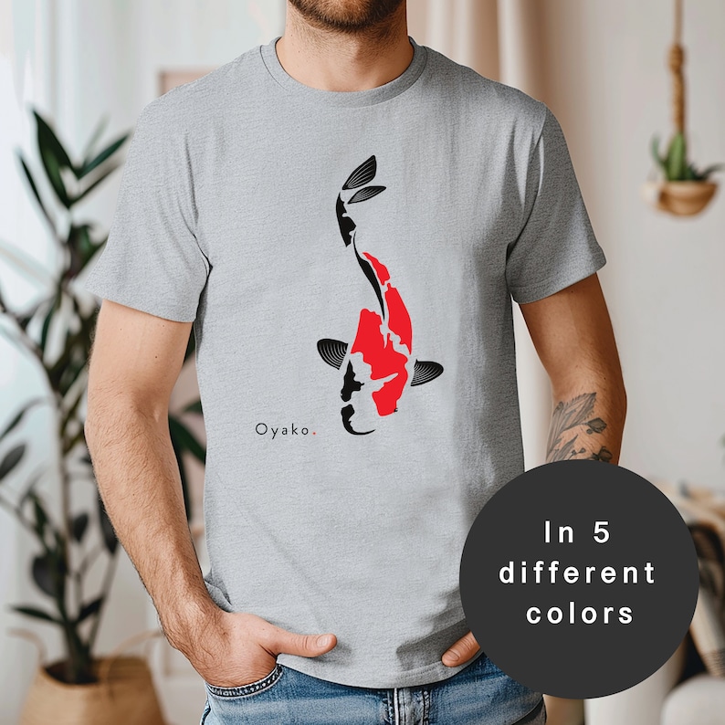 May include: A grey t-shirt with a black and red koi fish design. The text "Oyakō." is printed on the shirt. Available in 5 different colours.