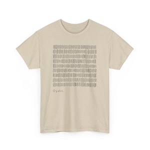 May include: A beige t-shirt featuring a black, rectangular pattern of vertical lines. The word "Oyako" is printed in black below the pattern. The shirt has short sleeves and a crew neck.