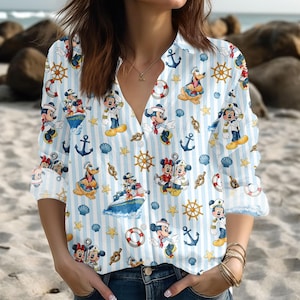 May include: A white ceramic mug with a black handle and the text "But First, Coffee" in a bold, black font. The mug is set against a blurred background, suggesting a cozy setting.