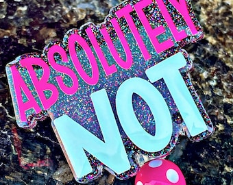 May include: A pink and blue glitter badge holder with the text "ABSOLUTELY NOT" and a pink mushroom charm with white polka dots.