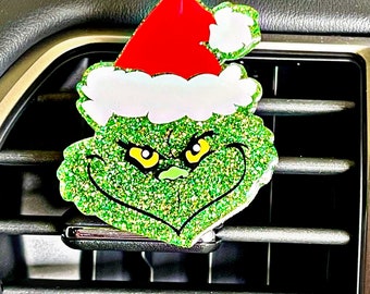 May include: Green glitter Grinch with a red and white Santa hat, a car air freshener.