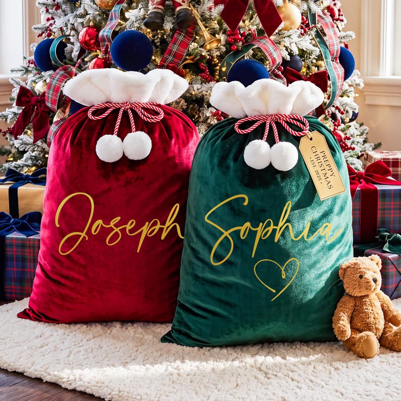 May include: Two velvet Christmas gift sacks, one deep red and one dark green, featuring white faux fur trim, red and white twisted rope drawstrings with white pom-poms, and gold script names. The green sack includes a tag reading PREPPY CHRISTMAS EST. 2025.