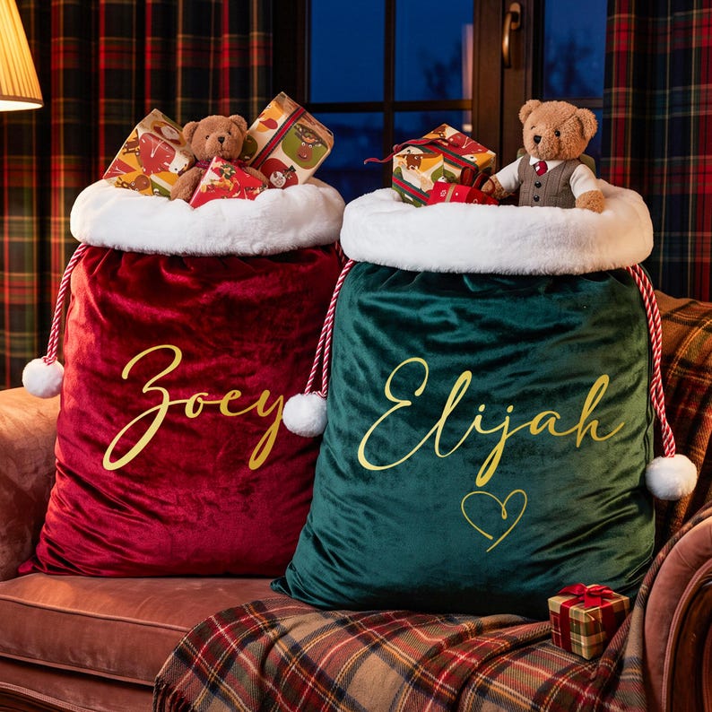 May include: Two large velvet Christmas gift sacks, one deep red with the name Zoey and one dark green with the name Elijah and a heart, both featuring white faux fur trim, red and white twisted rope drawstrings, and plush teddy bears on top.