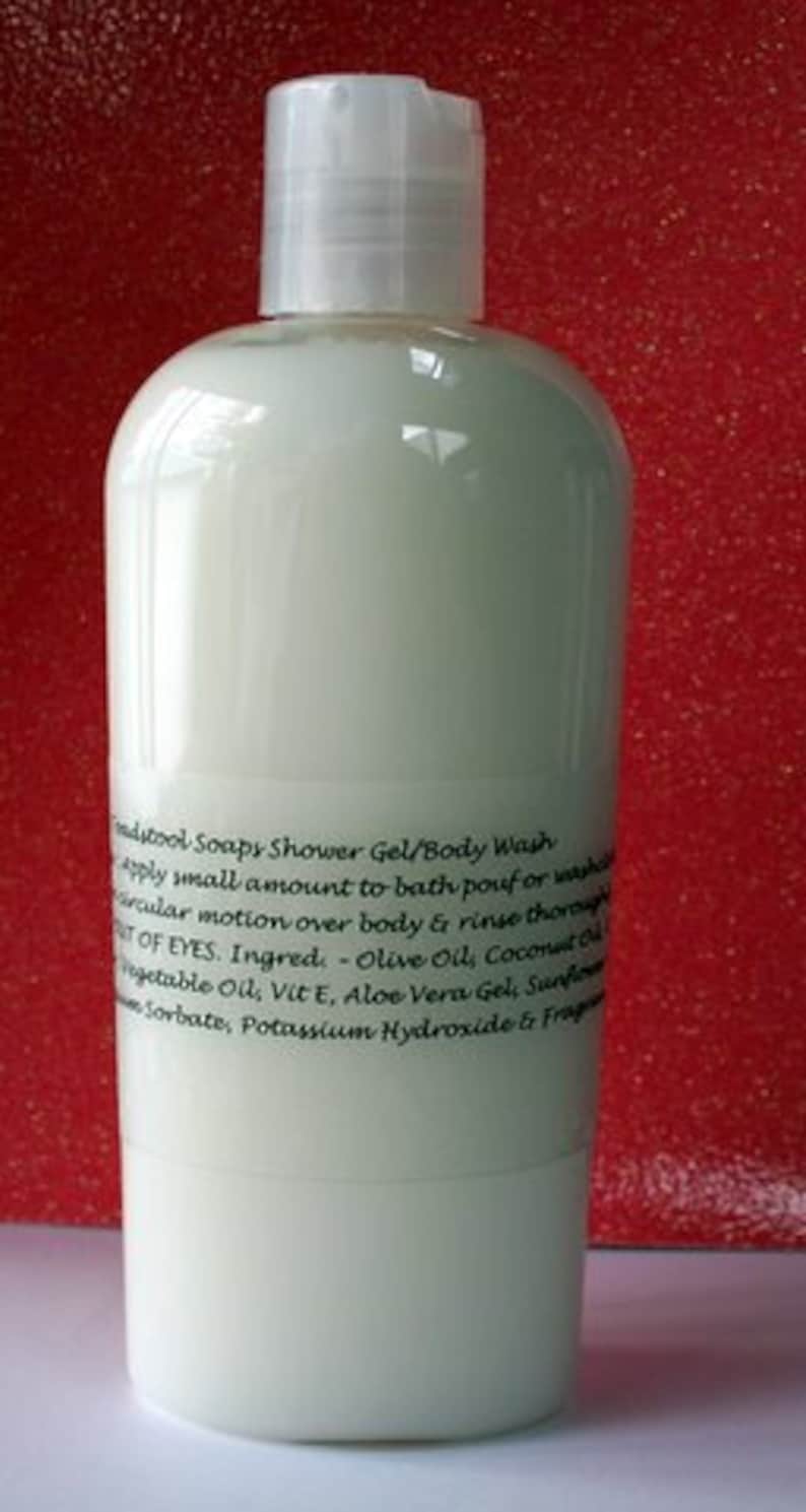 May include: A clear plastic bottle of body wash with a white label. The label has black text that reads "mdytool Soapy Shower Gel/Body Wash apply small amount to bath/pour or wash circular motion over body & rinse thoroughly OUT OF EYES. Ingred: Olive Oil, Coconut Oil Vegetable Oil, Vit E, Aloe Vera Gel, Sunflower Sorbate, Potassium Hydroxide & Fragrance"