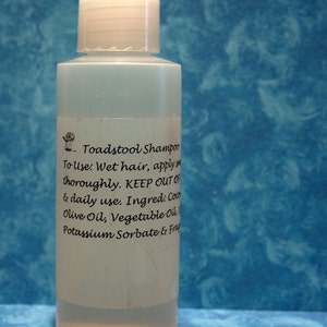 May include: A clear plastic bottle of Toadstool Shampoo with a white label. The label has black text that reads "Toadstool Shampoo", "To Use: Wet hair, apply thoroughly. KEEP OUT OF", "& daily use. Ingred: Coco", "Olive Oil, Vegetable Oil", "Potassium Sorbate & Frag".