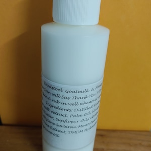 May include: A white plastic bottle with a white cap, labeled "Toadstool Goatmilk & Honey Skin will say Thank You!!" and listing ingredients: Distilled Water, Goat Milk Extract, Palm Oil, Mango Butter, Sunflower Oil, Cetearyl Alcohol, Sorbitan Monostearate, Aloe Vera Extract, DMDM Hydantoin, Fragrance Oil.