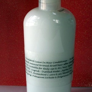May include: A clear plastic bottle of Toadstool Leave In Hair Conditioner. The bottle has a white label with black text that reads "Toadstool Leave In Hair Conditioner - To apply a small amount to towel dried hair after washing. Suitable for daily use & ALL hair types. Avoid EYES. Ingred - Distilled Water, Jojoba Oil, Vit E, Humectant (corn & soy blend), Preserving, Potassium Sorbate & fragrance."