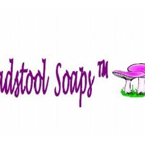 May include: Purple text reads "Toadstool Soapy" with a trademark symbol. The text is followed by a cartoon image of two pink mushrooms with white stems.