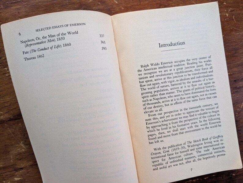K&ouml;nnte beinhalten: Ein ge&ouml;ffnetes Buch mit wei&szlig;em Hintergrund und braunem Einband. Das Buch tr&auml;gt den Titel "Selected Essays of Emerson" und enth&auml;lt eine Liste von Essays mit ihren Ver&ouml;ffentlichungsdaten. Der Text auf der rechten Seite ist eine Einleitung zum Buch, die sich mit den Werken von Ralph Waldo Emerson befasst.