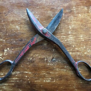 May include: Vintage red and black metal shears with the words "Chicago Cutlery Co." stamped on the handle.
