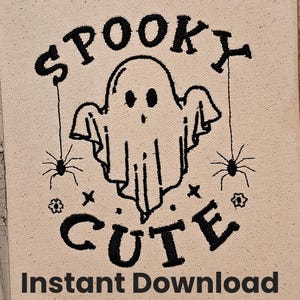 May include: Black and white embroidery design of a ghost with the words "Spooky Cute" above it and two spiders hanging from strings on either side of the ghost.