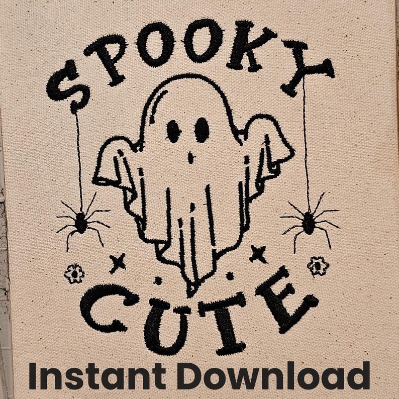 May include: Black and white embroidery design of a ghost with the words "Spooky Cute" above it and two spiders hanging from strings on either side of the ghost.