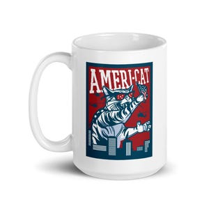 May include: White ceramic mug with a red, white, and blue illustration of a cat wearing sunglasses and holding an American flag. The text "AMERI-CAT" is printed in blue on a red background.