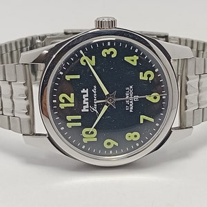 Relógio de pulso masculino HMT Janata vintage genuíno fabricado na Índia com mostrador luminoso e mostrador preto e 17 joias