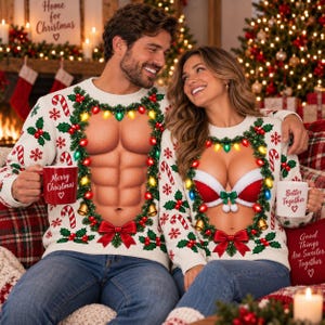 May include: Two white long-sleeve jumpers featuring a festive holiday print of a wreath made of pine branches, red berries, candy canes, and colourful lights. One jumper displays a muscular torso, the other a red and white bra.