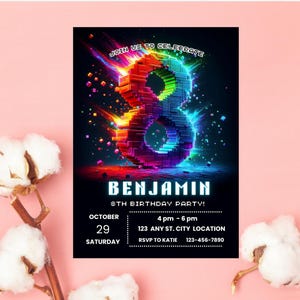 May include: A rectangular birthday party invitation card featuring a large, colorful, pixelated number eight in the center. The text reads: JOIN US TO CELEBRATE, BENJAMIN, 8TH BIRTHDAY PARTY!, OCTOBER 29 SATURDAY, 4 pm - 6 pm, 123 ANY ST. CITY LOCATION, RSVP TO KATIE 123-456-7890.