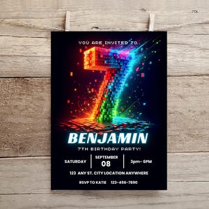 May include: A birthday party invitation card featuring a large, glowing number seven constructed from colorful, pixelated blocks against a black background. The text reads: YOU ARE INVITED TO, BENJAMIN, 7TH BIRTHDAY PARTY, SATURDAY, SEPTEMBER 08, 3pm- 6PM, 123 ANY ST. CITY LOCATION ANYWHERE, RSVP TO KATIE 123-456-7890.