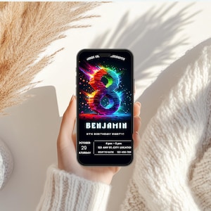 May include: A smartphone displaying a digital birthday invitation featuring a large, glowing, multi-colored number eight. The text reads: JOIN US TO CELEBRATE, BENJAMIN, 8TH BIRTHDAY PARTY, OCTOBER 29 SATURDAY, 4 pm - 6 pm, 123 ANY ST. CITY LOCATION, RSVP TO KATIE 123-456-7890.