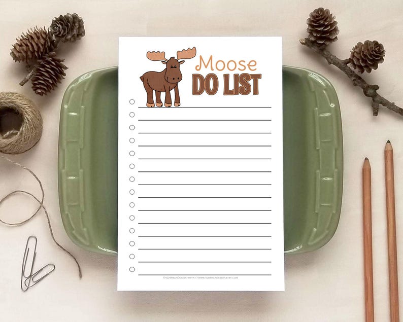 May include: A white rectangular notepad featuring a cartoon brown moose illustration and the text "Moose DO LIST" in brown letters. The notepad includes a vertical column of circular checkboxes followed by horizontal lines for writing tasks.