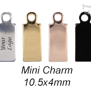 May include: Four mini charms in silver, gold, rose gold, and black. Each charm is rectangular with a small loop at the top. The silver charm has the text "Your Logo" engraved on it. The charms are 10.5 mm by 4 mm.