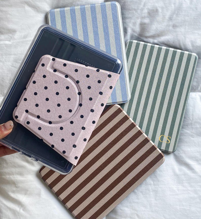 Detachable magnetic back Kindle case with clear cover and printed polka dot design. Rotating stand compatible Kindle Paperwhite case allowing easy attachment and removal while protecting the device.