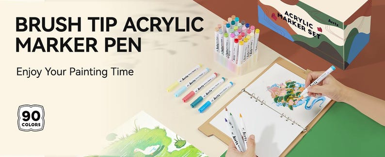 Pode incluir: Um conjunto de 90 marcadores acr&iacute;licos de ponta de pincel em uma variedade de cores. Os marcadores est&atilde;o em um recipiente de pl&aacute;stico transparente e s&atilde;o etiquetados como "Acrylic Marker Set".