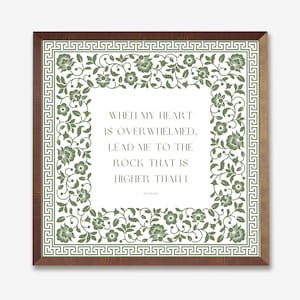 May include: A framed print with a white background and a green floral border. The print features a quote that reads: "When my heart is overwhelmed, lead me to the rock that is higher than I."