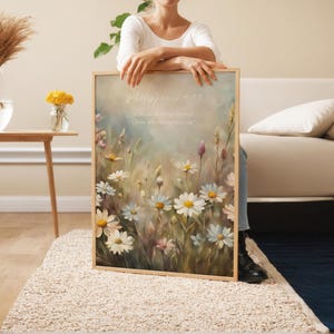 May include: A framed print featuring a watercolour painting of a field of white daisies. The print has a light blue background and the text "Philippians 4:13 I can do all things through Christ who strengthens me." is printed in white at the top.