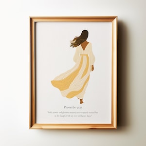 May include: A framed print featuring a minimalist illustration of a woman in a flowing yellow dress. The text "Proverbs 31:25" and a quote from the Bible verse are included below the illustration.