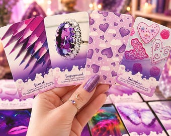 May include: A hand holds four rectangular oracle cards with purple themes. The cards feature images of sharpened pencils, a large oval amethyst ring, a pattern of purple hearts and clouds, and heart-shaped cookies with the text Valentine.