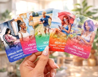May include: A set of five rectangular astrology cards held in a hand. The cards feature illustrations of people and text including Uranus Retrograde, Virgo, Sextile, Mercury, and Taurus, with associated keywords like Diligence, Intellect, and Creativity.