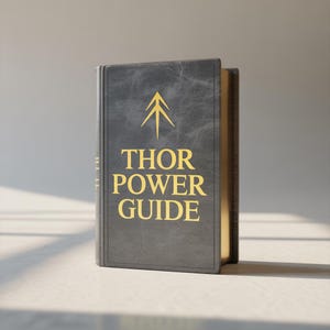 May include: A hardcover book with the title "THOR POWER GUIDE" in gold lettering. The cover is dark gray with a gold arrow symbol. The book's pages have a gold edge. The book is standing upright.