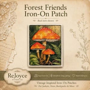 May include: A rectangular iron-on patch featuring a detailed illustration of three orange-capped mushrooms nestled among green ferns. The text Forest Friends Iron-On Patch is printed above the patch, with ReJoyce Studio AZ branding below.