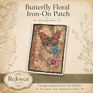 May include: A rectangular iron-on patch featuring a butterfly and floral design in shades of orange, blue, and pink on a textured background. The patch has a dark stitched border. Text on the image reads Butterfly Floral Iron-On Patch.