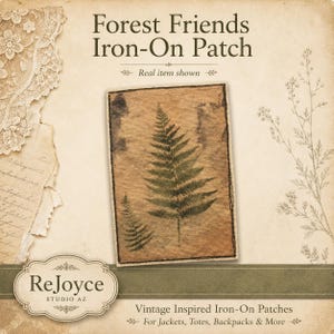 May include: A rectangular iron-on patch featuring a brown, textured background with two dark green fern leaf illustrations. The patch has a stitched border and is displayed with text that reads Forest Friends Iron-On Patch, ReJoyce Studio AZ, and Vintage Inspired Iron-On Patches.