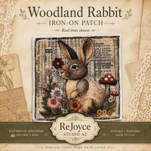 May include: A square iron-on patch featuring a brown rabbit sitting among colorful flowers and mushrooms. The background of the patch has a vintage newspaper print. The text on the patch packaging reads Woodland Rabbit, Iron-On Patch, and ReJoyce Studio AZ.