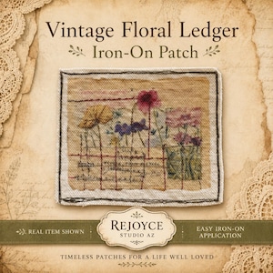 May include: A rectangular iron-on patch featuring a beige fabric background with a printed design of colorful wildflowers and grid lines resembling a ledger page. The patch has a dark stitched border and includes the text Vintage Floral Ledger Iron-On Patch.
