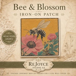 May include: A square iron-on patch featuring a detailed embroidered design of a bee hovering over a large pink flower with green leaves on a mustard yellow background. The patch has a white stitched border and is displayed on a textured background.