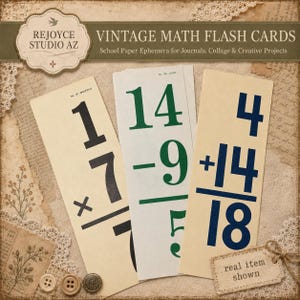May include: Three rectangular math flash cards with cream-colored paper. The left card has black text showing 1 times 7. The center card has green text showing 14 minus 9 equals 5. The right card has dark blue text showing 4 plus 14 equals 18.