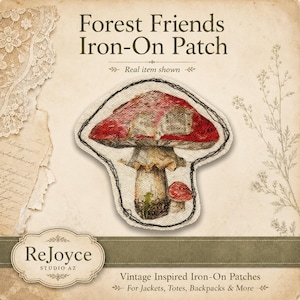 May include: An iron-on patch featuring a large red mushroom with a smaller red mushroom beside it. The patch has a textured fabric appearance with a dark stitched border. Text reads: Forest Friends Iron-On Patch, ReJoyce Studio AZ.
