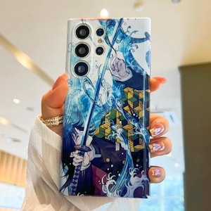 Pu&ograve; includere: Una custodia per telefono bianca con un design di personaggio anime blu e giallo. Il personaggio tiene una spada ed &egrave; circondato dall'acqua. La custodia del telefono ha un ritaglio per la fotocamera con tre obiettivi.