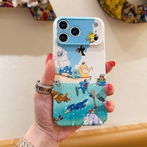 May include: A white and blue phone case featuring a cartoon illustration of various creatures in a boat on the water. The case has a blue top section with camera cutouts and a white base.